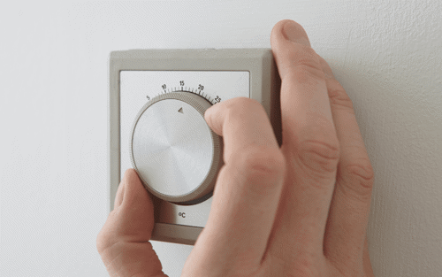 Man lowering thermostat