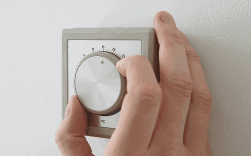 Man lowering thermostat