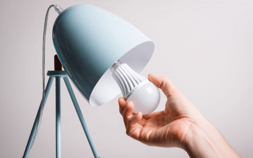 Man puts LED bulb in lamp