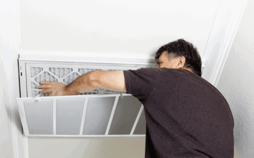 Man changing AC filter