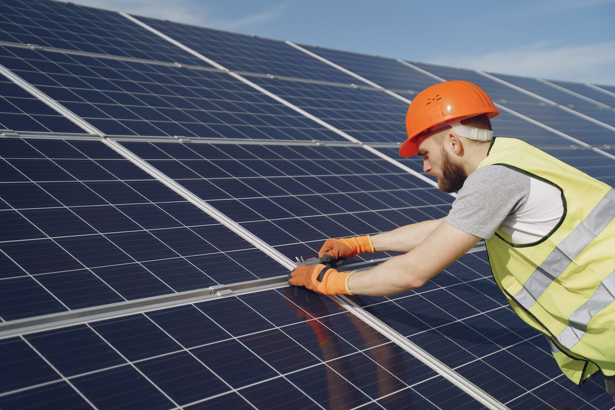 man working on solar panel