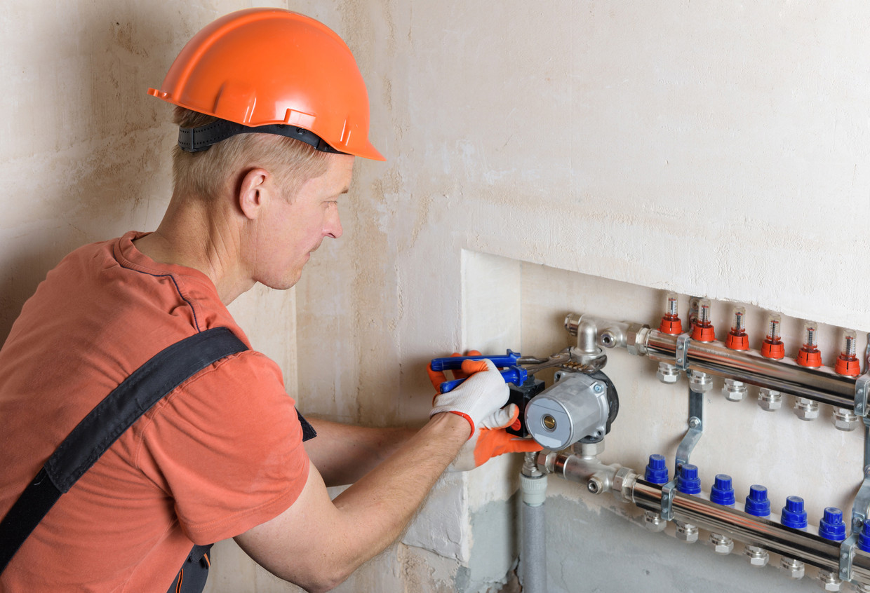 man fixing water heater